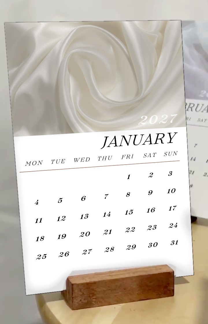 The calendar side of a card on its wooden stand: January 2027